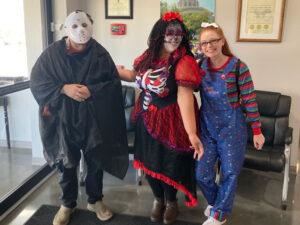 Three people dressed up for Halloween.