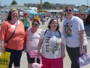 Group of ladies smiling at a fair.